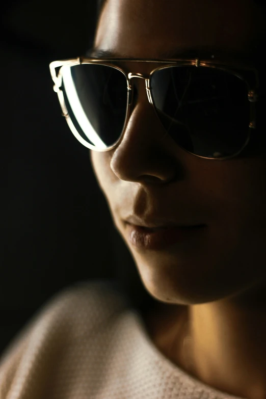 a woman in shades looking off to the side