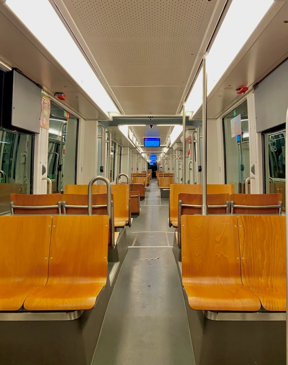 the interior of an empty train car with leather seats