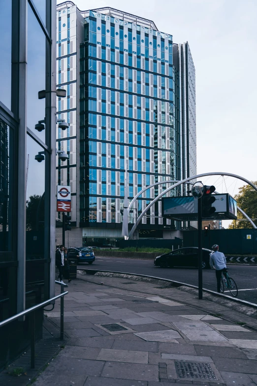 a man is standing in front of a very tall building