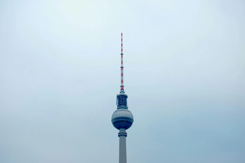 a tall building with a white and red top