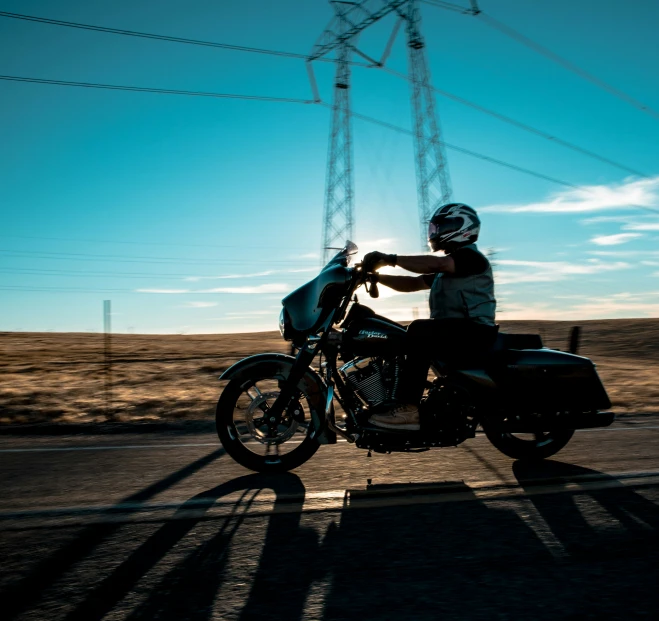 the motorcycle rider is riding down the road