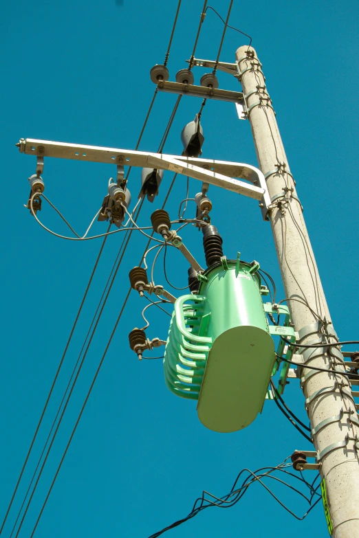 an electric pole is standing tall with some wires