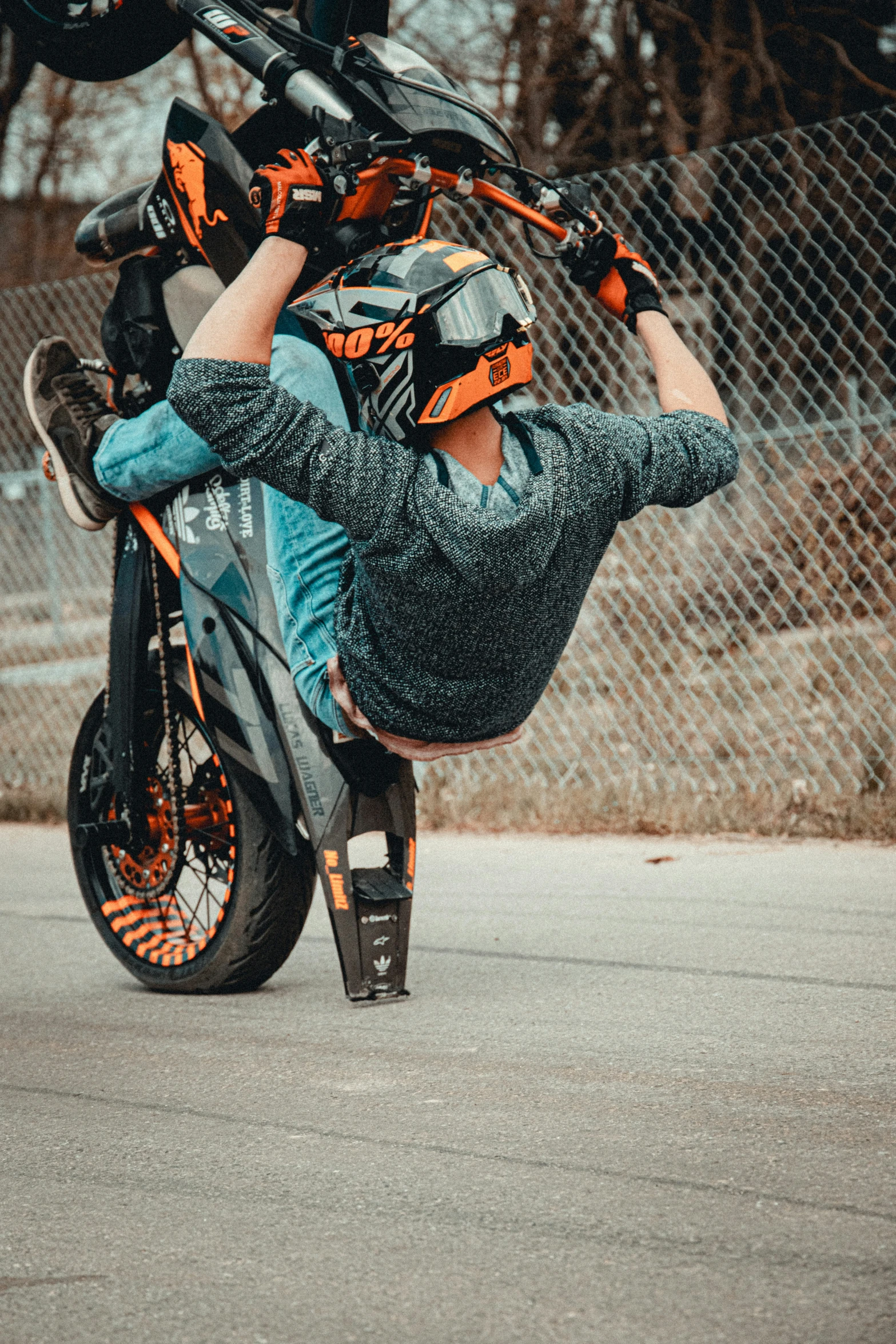 a man is upside down on his motorcycle