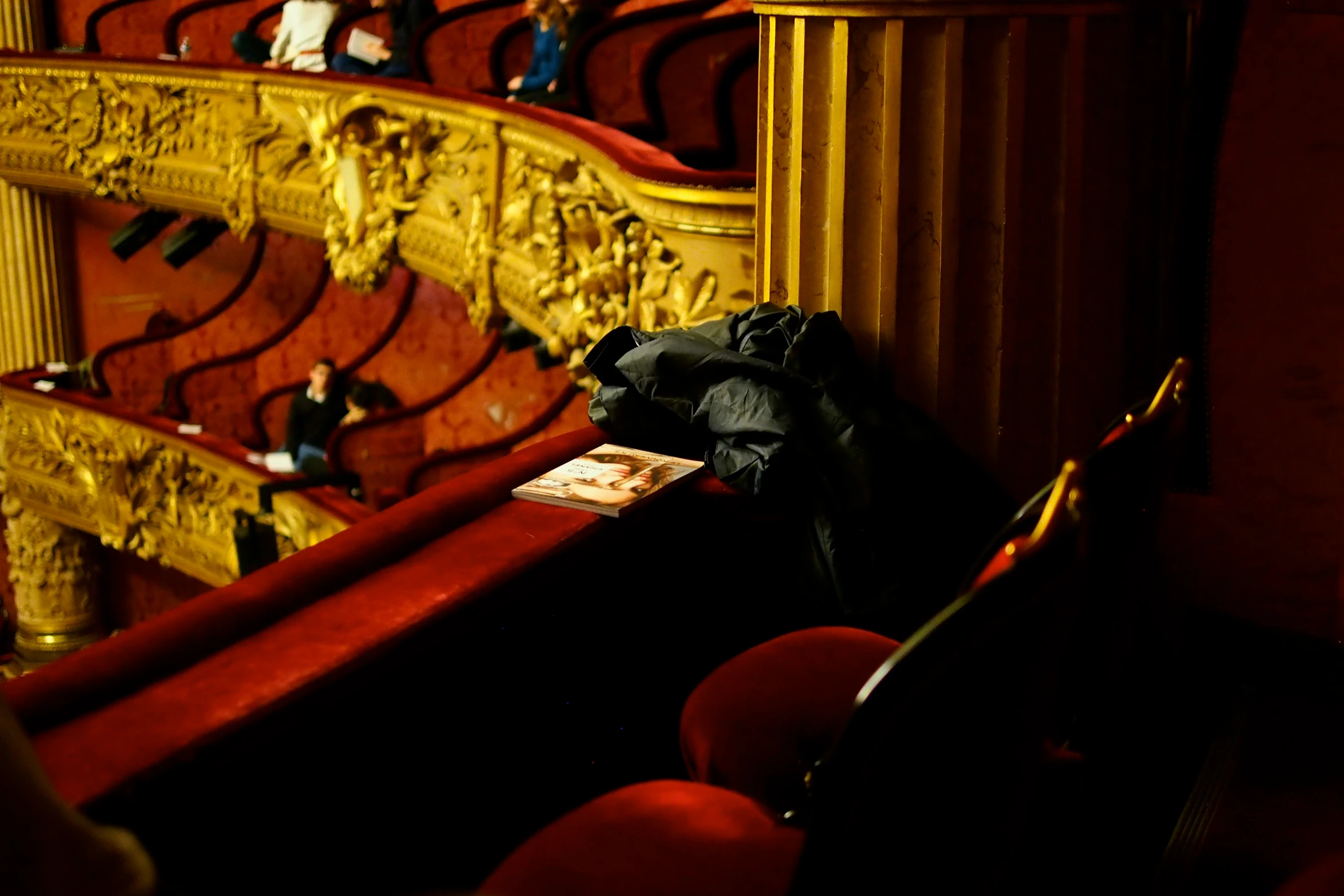 a black bag sitting on a red bench