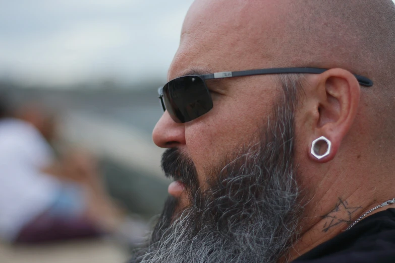 a close up of a man with a shaved head