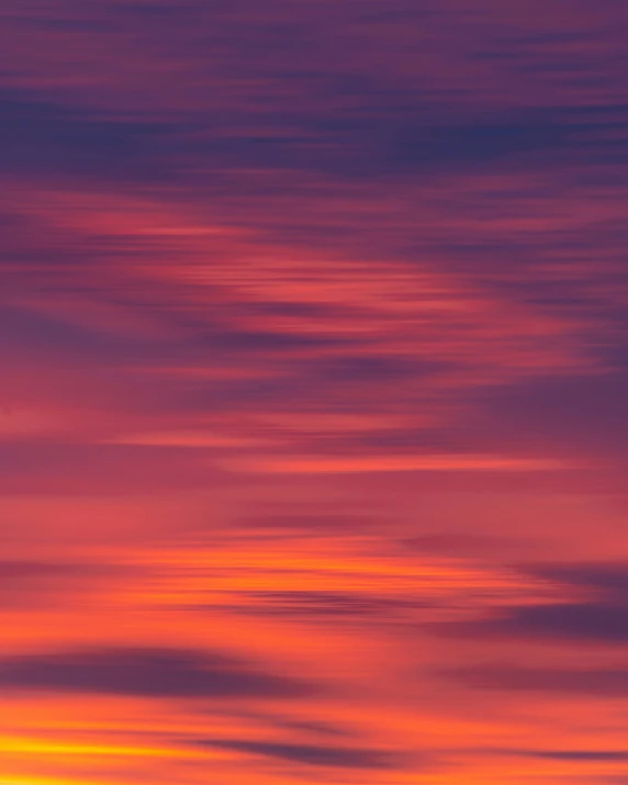 the silhouette of a plane as it crosses over an orange and pink sky