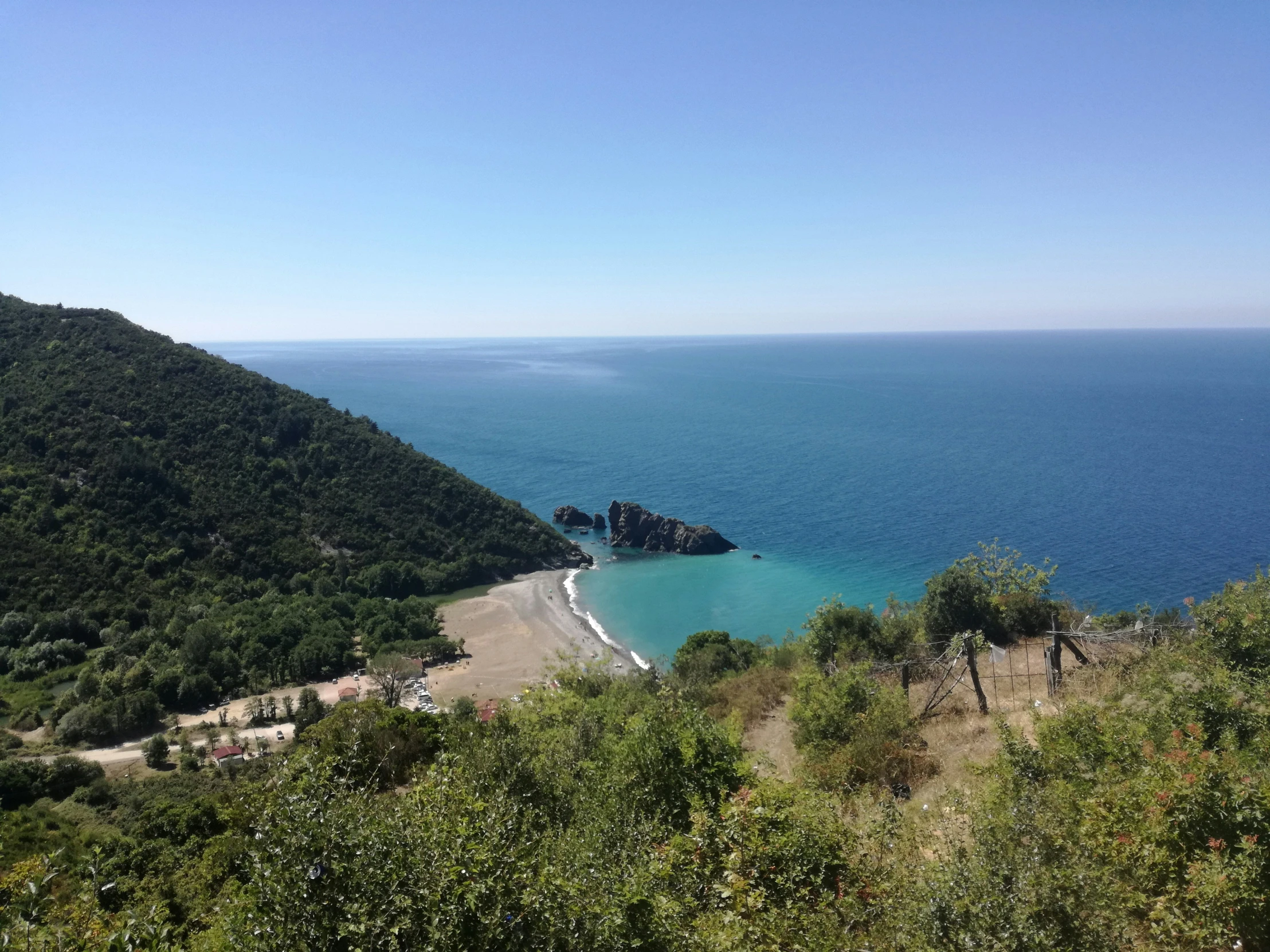 a blue body of water sitting between two hills