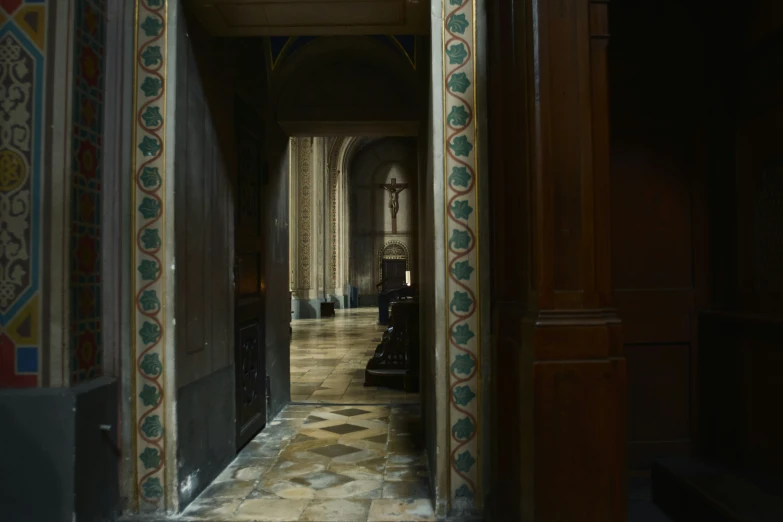 a hallway with a tiled floor and walls in the house