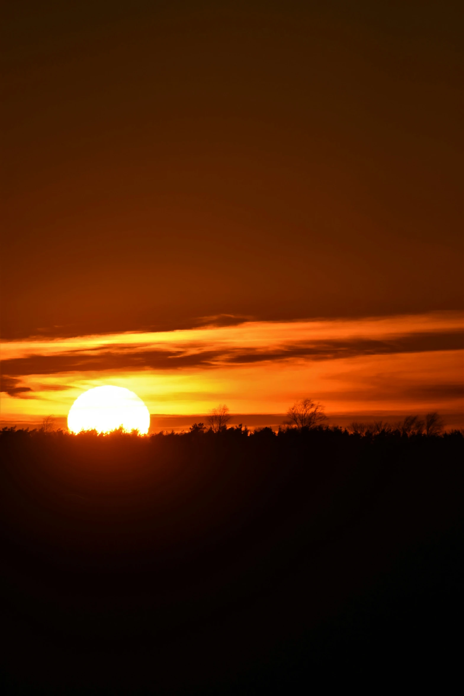 a very beautiful orange and yellow sunset with clouds