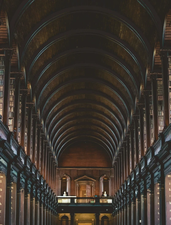 rows of wooden bookshelves lined up in a liry