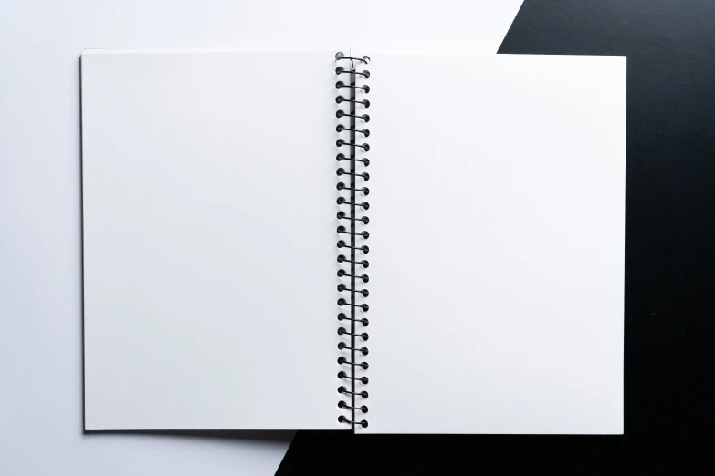 spiral notebook open on top of a table