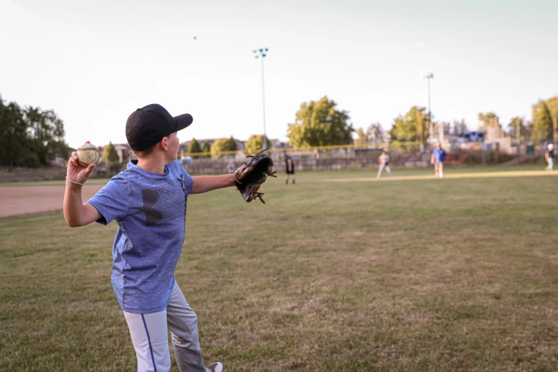 a  prepares to catch a ball while the other player waits