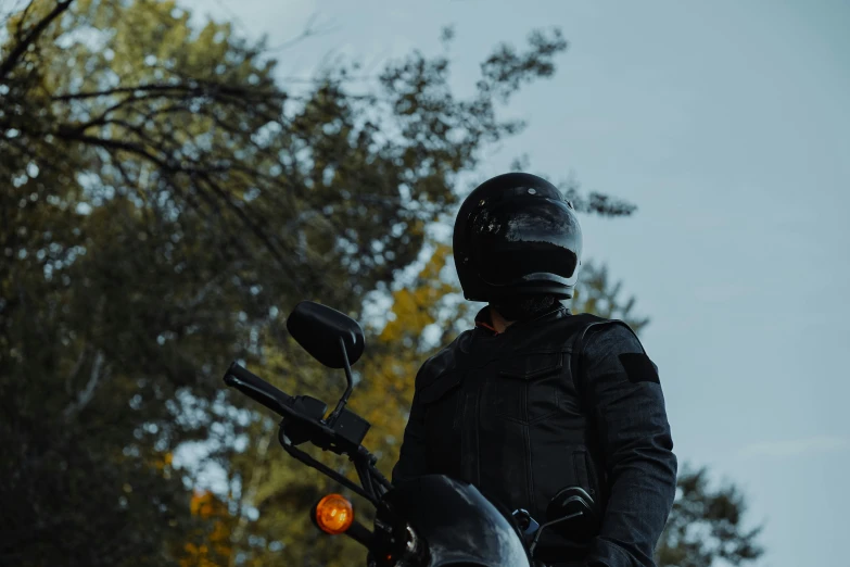 the person is on a motorcycle wearing a black jacket