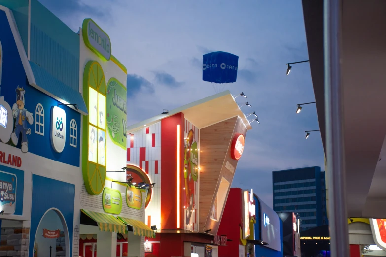 city buildings in a city at dusk with lit signs