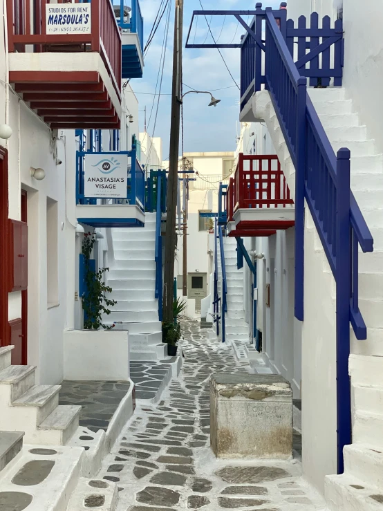 a narrow alleyway with several steps and railings