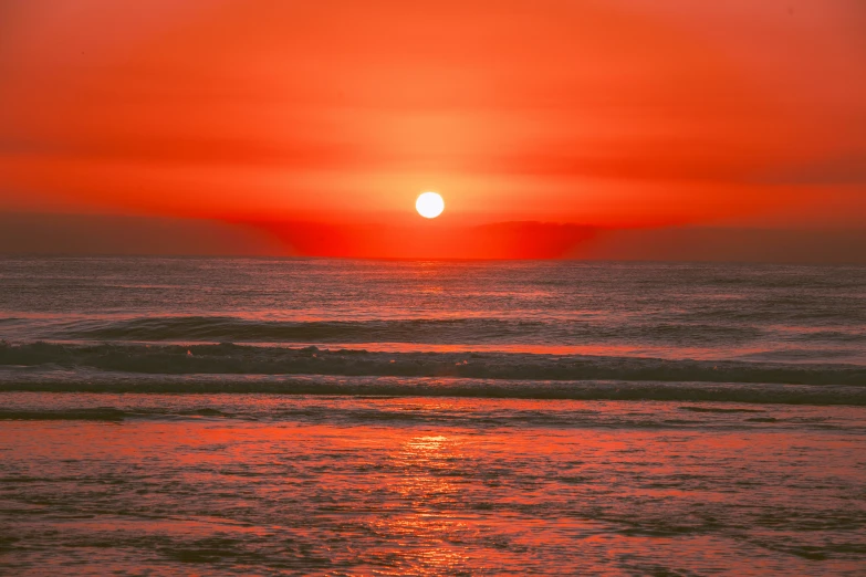 sunset view from beach with a small wave