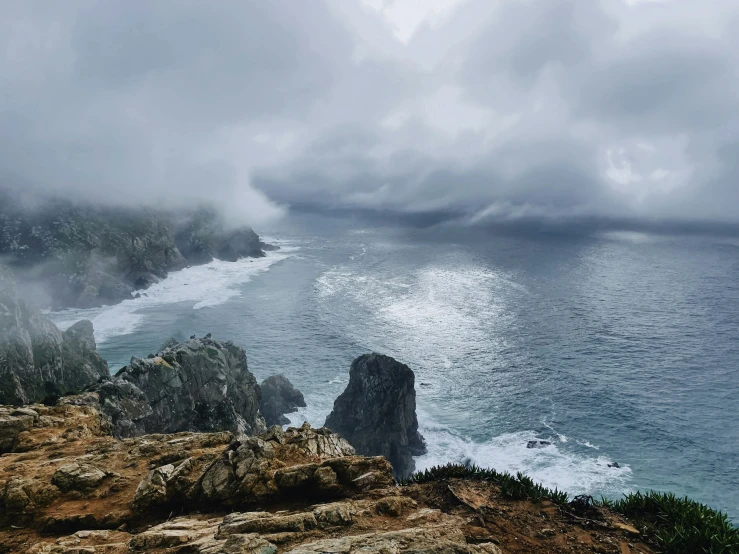 an aerial view of water and rocks in the ocean