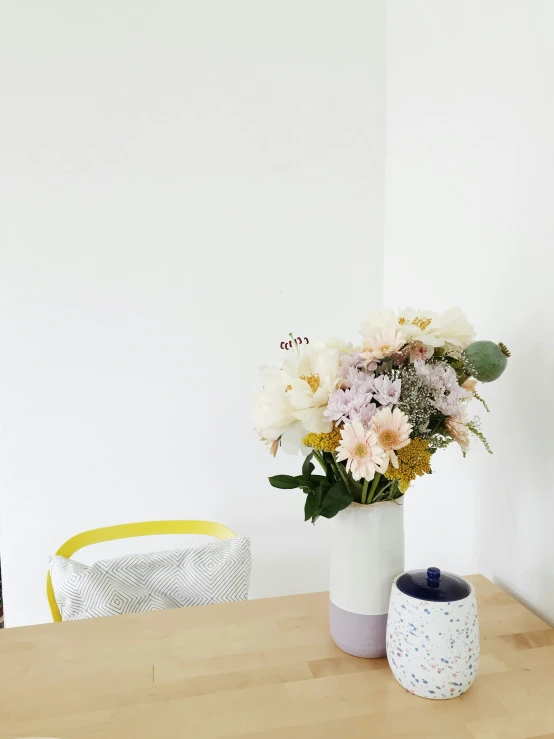 a vase with flowers on a wooden table