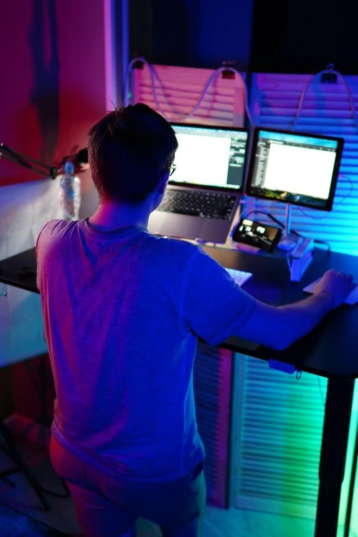 a man in front of two computer screens
