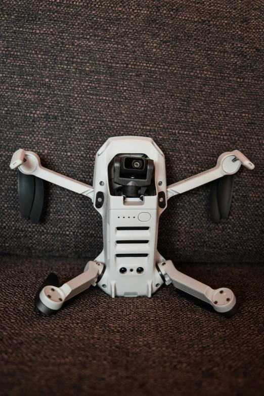 a white robot with camera attached to its chest