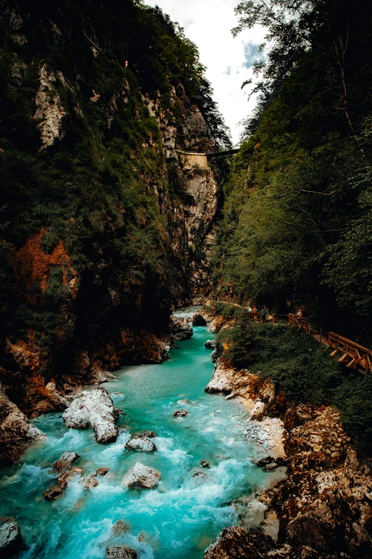 the water is green and blue in the mountain