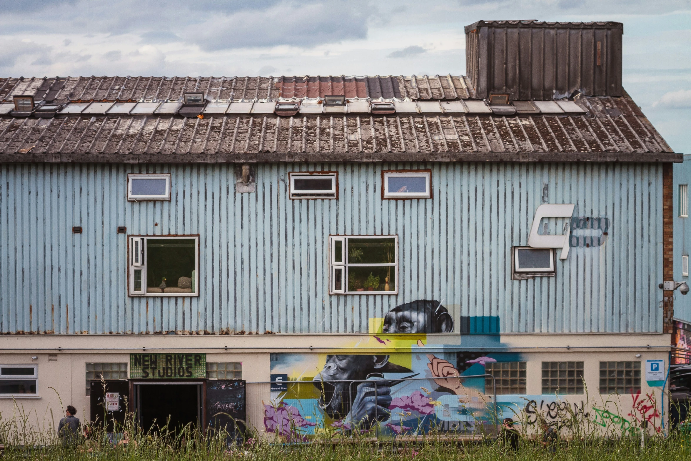 the blue building is covered with graffiti