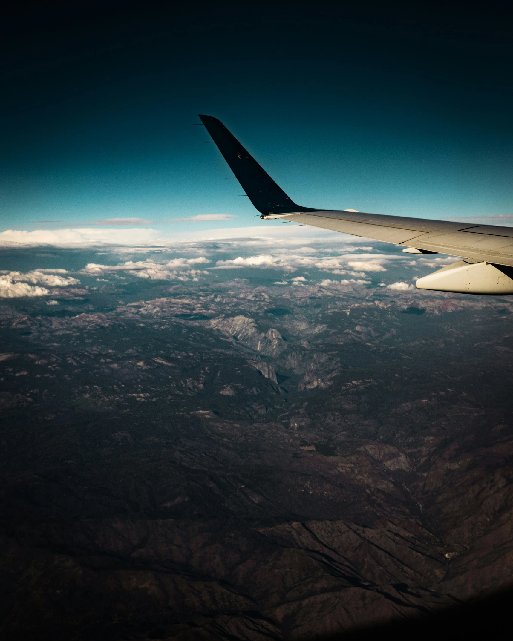 an aerial s of the wing and bottom part of an airplane