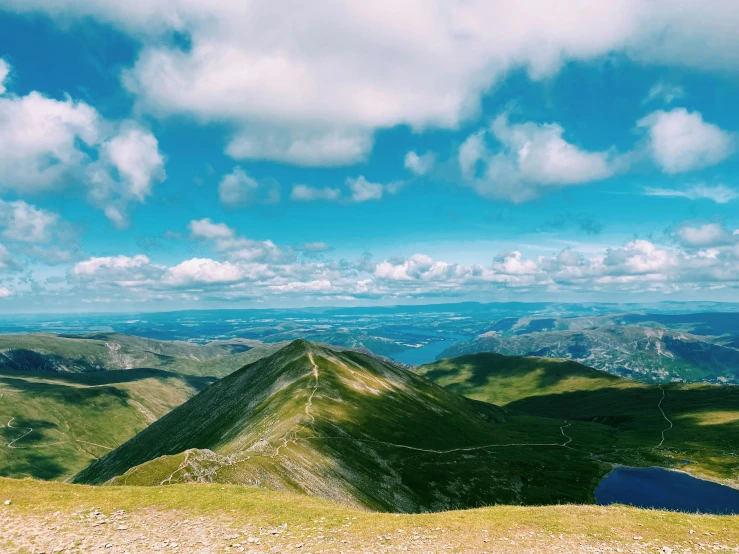 a mountain overlook with a blue bench on top of it