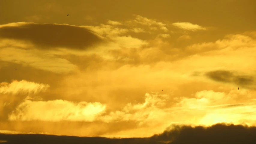 a bright orange sky with yellow and red clouds