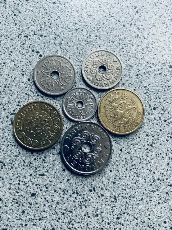 six pound coins lying on a table