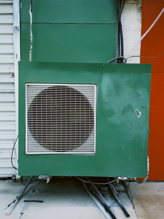 a heater sitting inside of an open green box