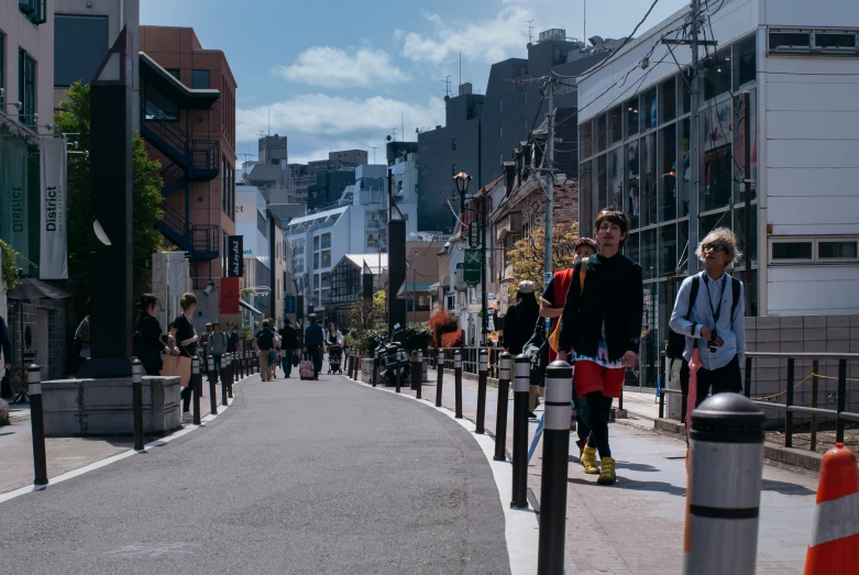 several people walking down an empty city street