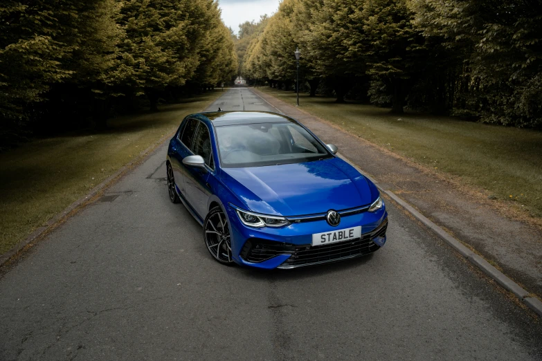 an image of a blue car parked on the side of a road