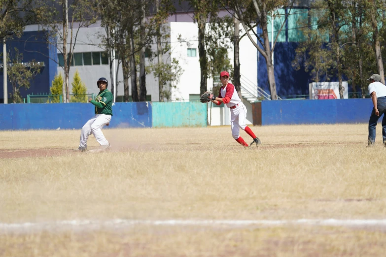 three s playing baseball in an open field