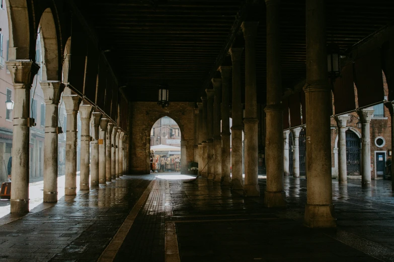 long stone columns are lining the inside of a large room