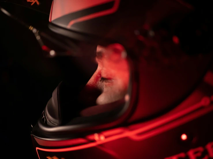 an illuminated image of the helmet of a race car driver