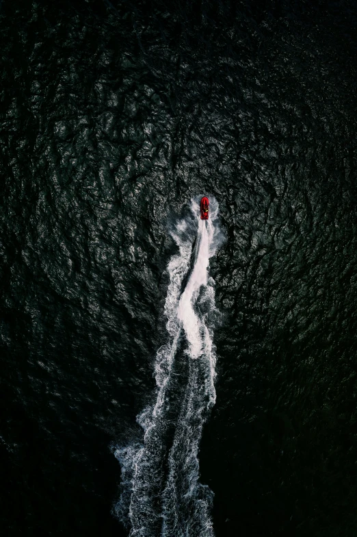 the boat is in the water next to some red and white object