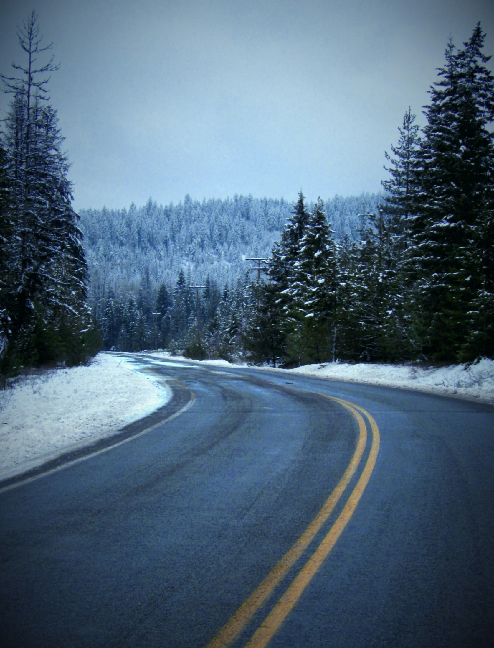 an empty road with snow on the ground