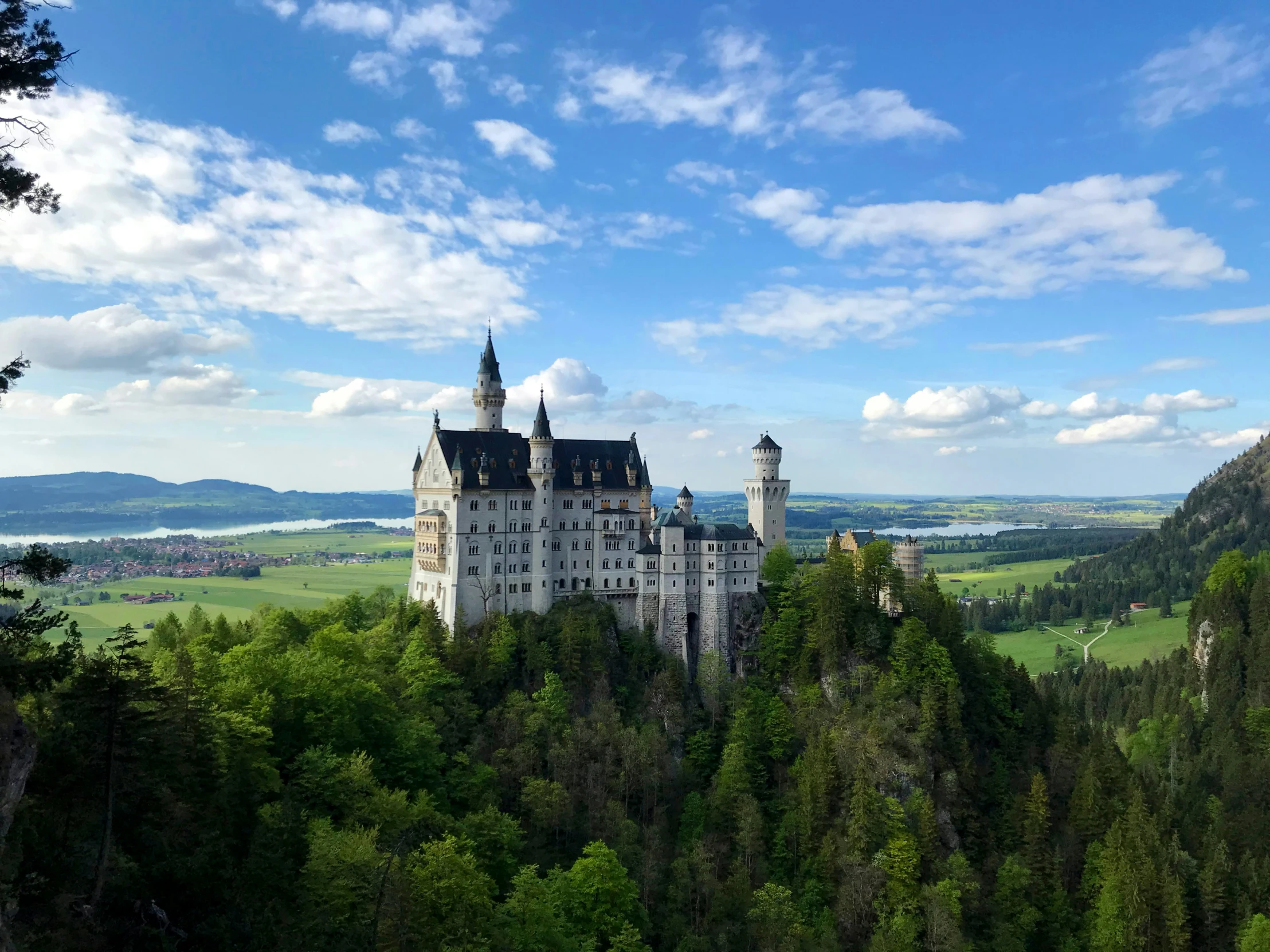 a castle is seen nestled up on a rocky cliff