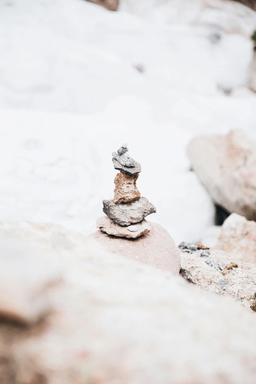 a small tower sitting on top of rocks in the snow