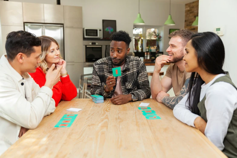 the three friends are sitting together playing a board game