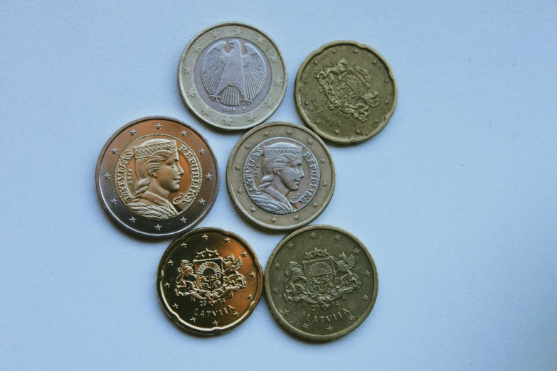 four different coin type coins of different countries