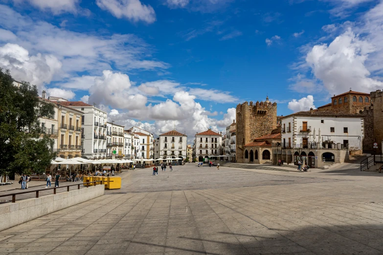 many people are walking in an empty square