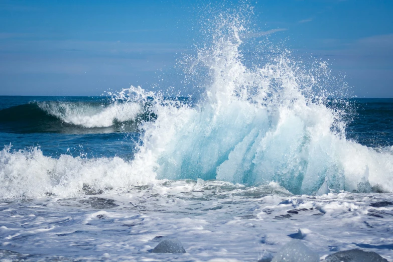 the water is splashing up over the ocean wave