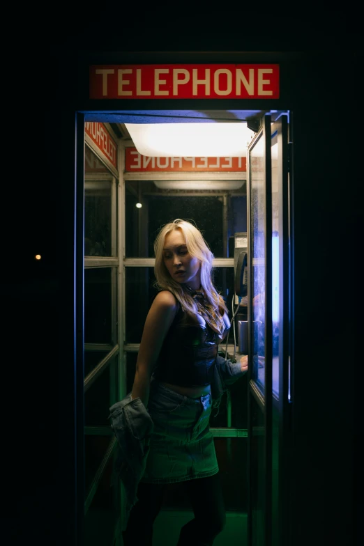 woman standing in the doorway of a telephone booth