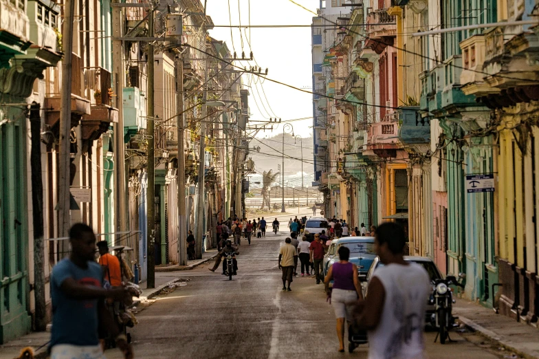 people walking down the side of a city street