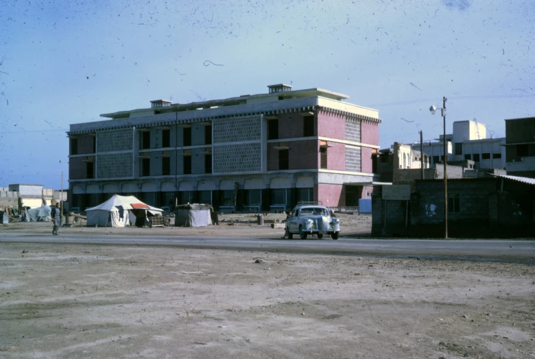 an old pick up truck parked in front of a building