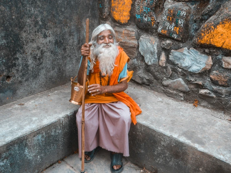 the old man is dressed in his orange outfit