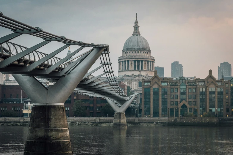 the bridge is designed like a sculpture in front of a large cityscape