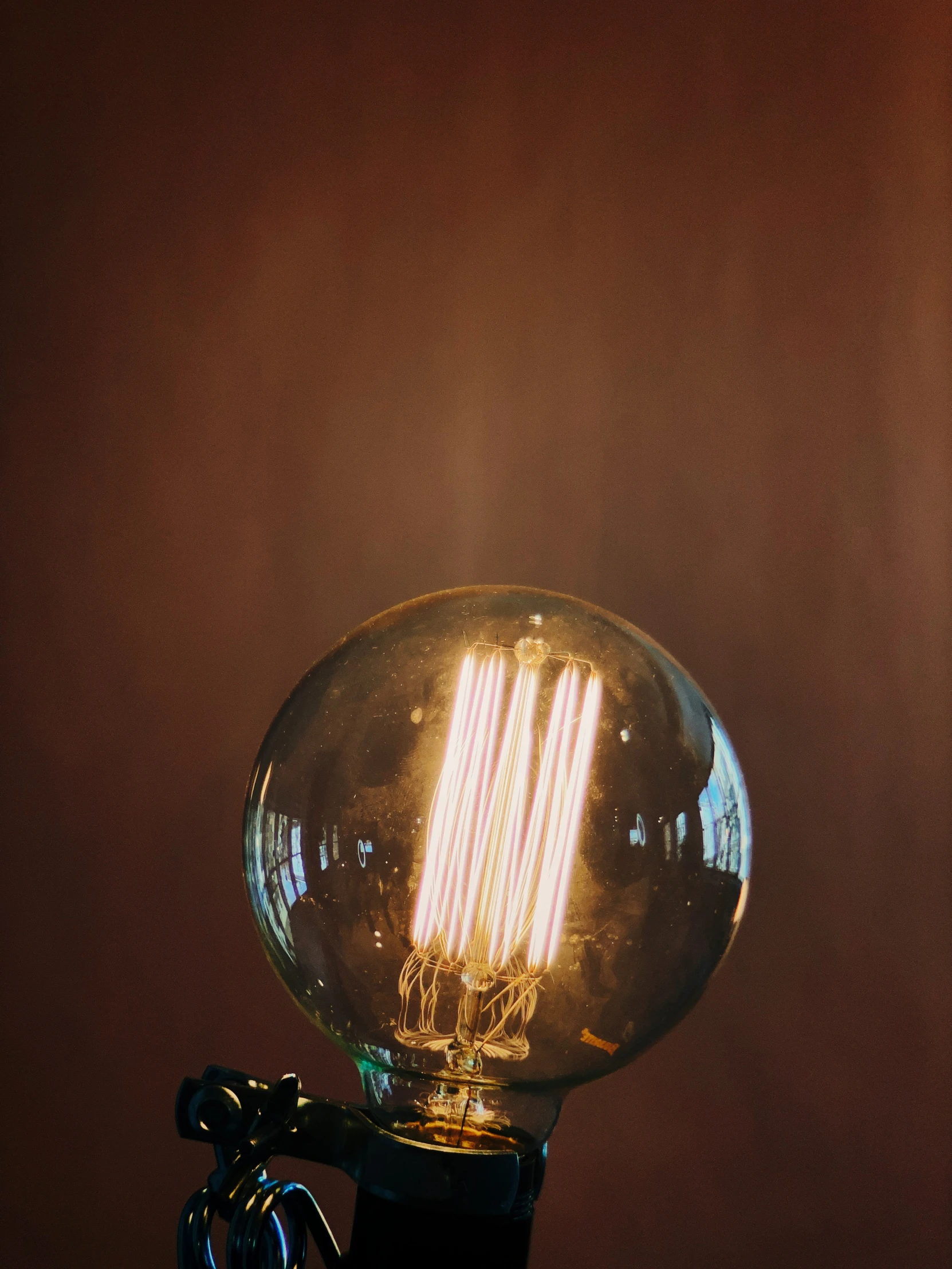 a bright light bulb sitting on top of a piece of glass